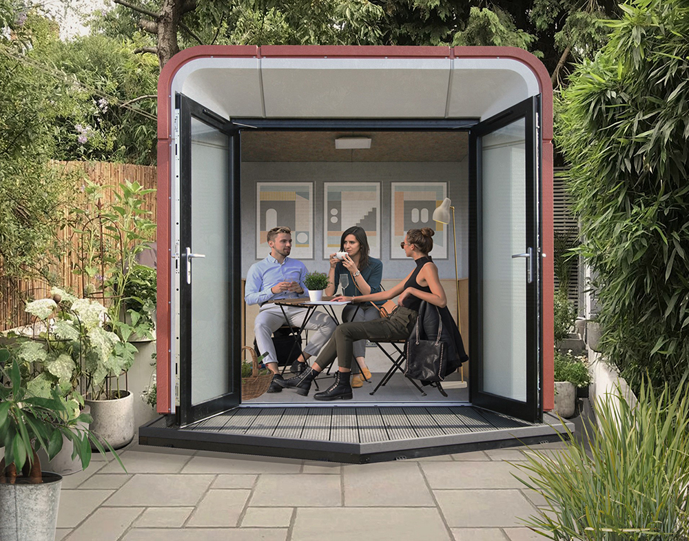 three people sitting in a contemporary garden room, with doors fully open